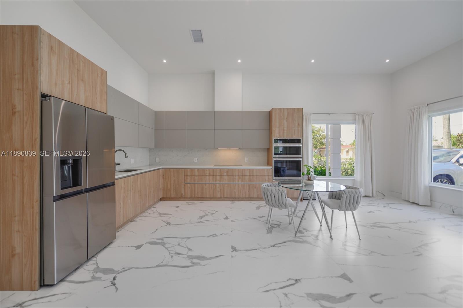 635 Southwest 9th Street Hallandale Beach, FL 33009 - Photo 8 of 38 a living room with stainless steel appliances furniture a rug and a kitchen view