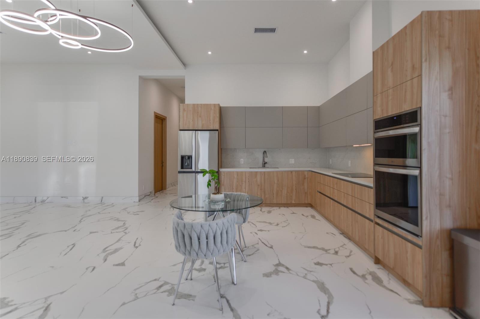 635 Southwest 9th Street Hallandale Beach, FL 33009 - Photo 9 of 38 a kitchen with stainless steel appliances kitchen island granite countertop a sink and cabinets