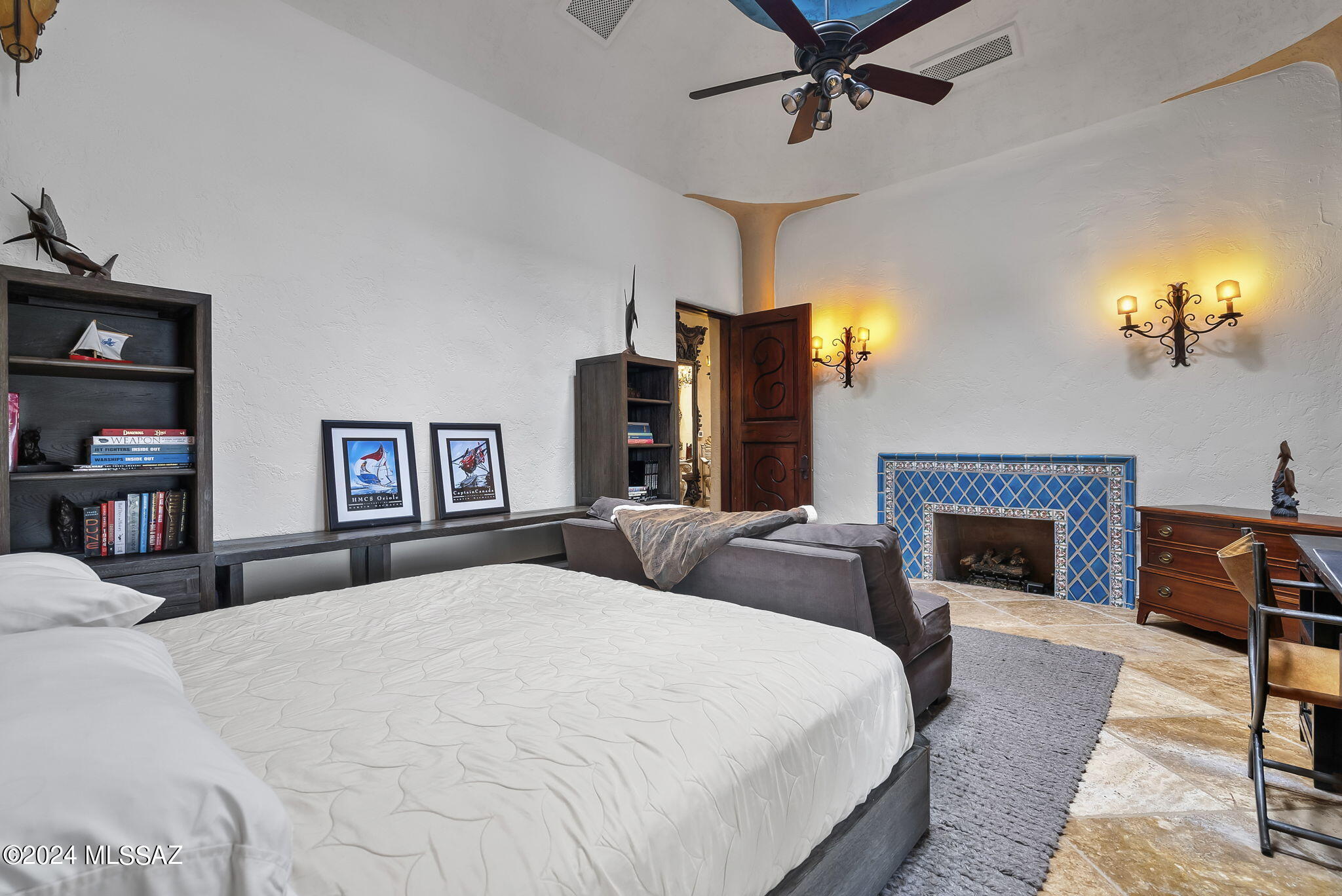 45 Clark Crossing Road Tumacacori, AZ 85640 - Photo 15 of 50 a bedroom with a large bed and a fireplace
