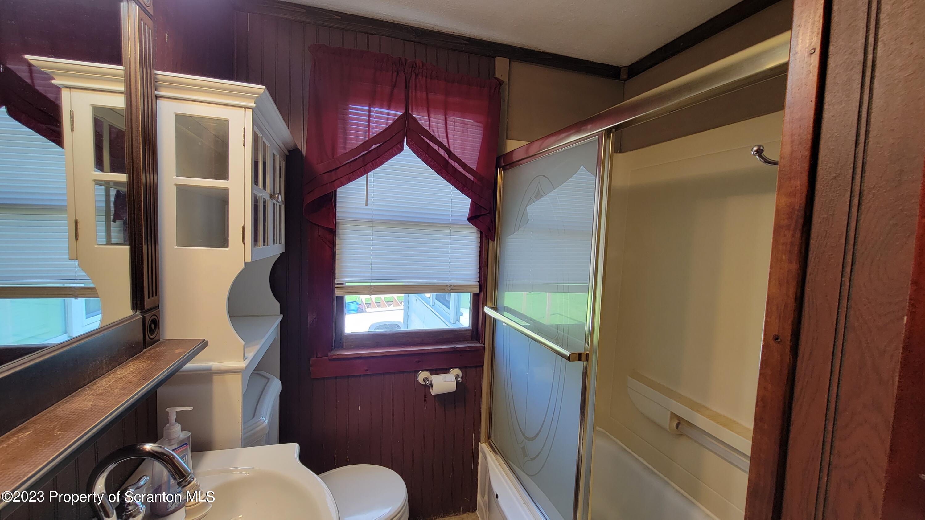 14 Main Street Hallstead, PA 18822 - Photo 11 of 16 a bathroom with a toilet sink and mirror