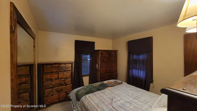 a bedroom with a bed and a television