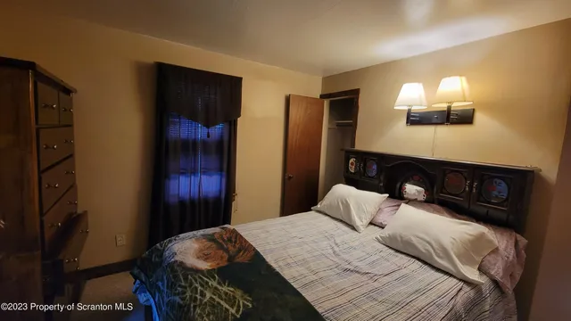 a bedroom with a bed and a mirror