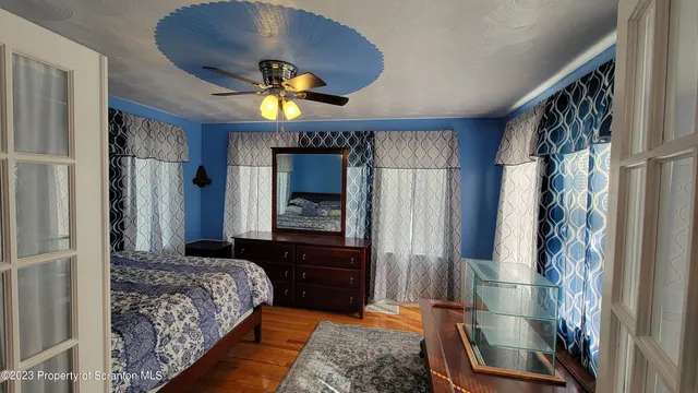 a bedroom with a bed and a mirror on the dresser