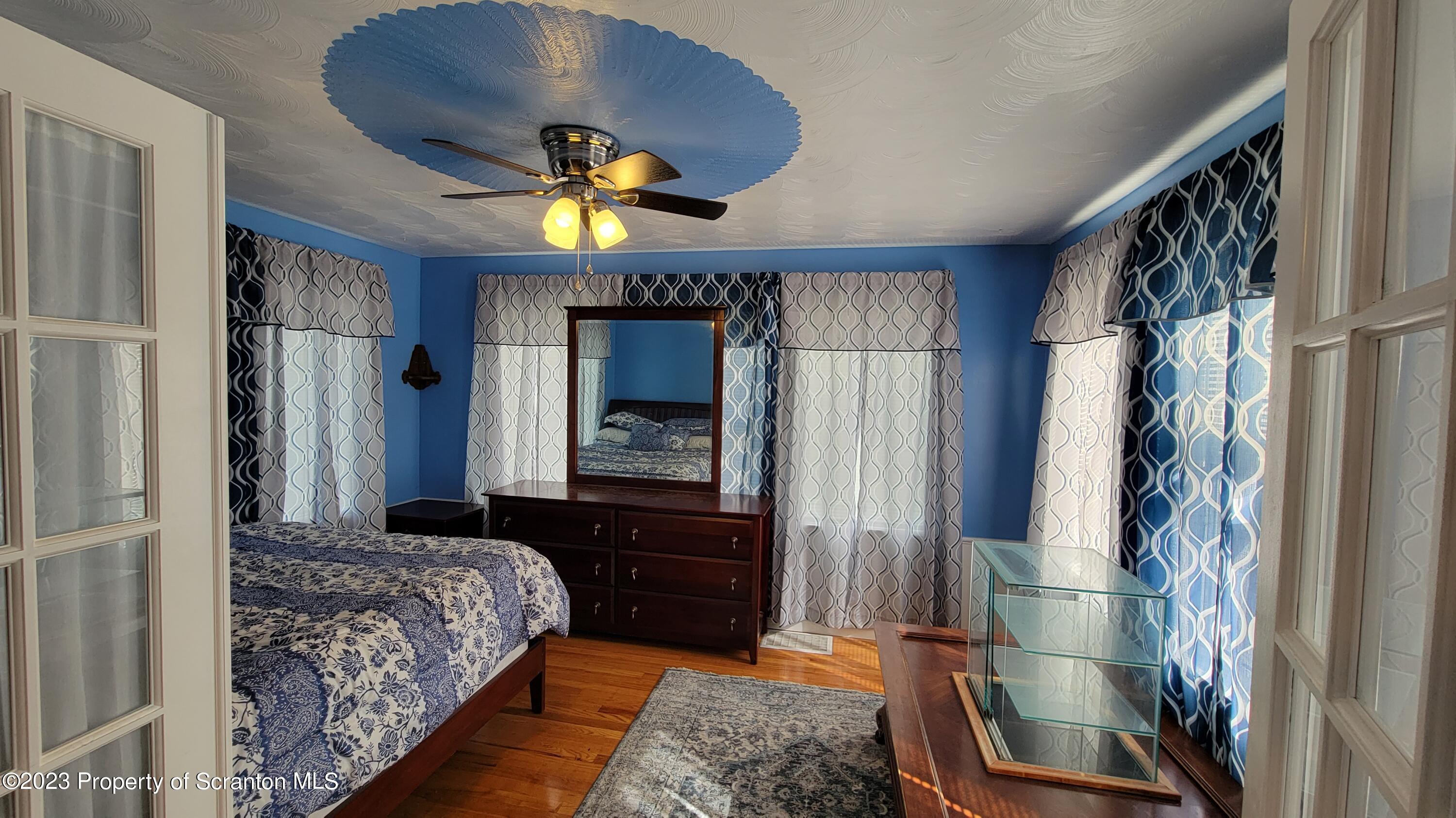 14 Main Street Hallstead, PA 18822 - Photo 5 of 16 a bedroom with a bed and a mirror on the dresser
