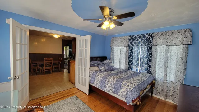 a bedroom with a bed and a chandelier