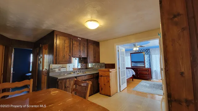 a open kitchen with kitchen island a sink stove and refrigerator