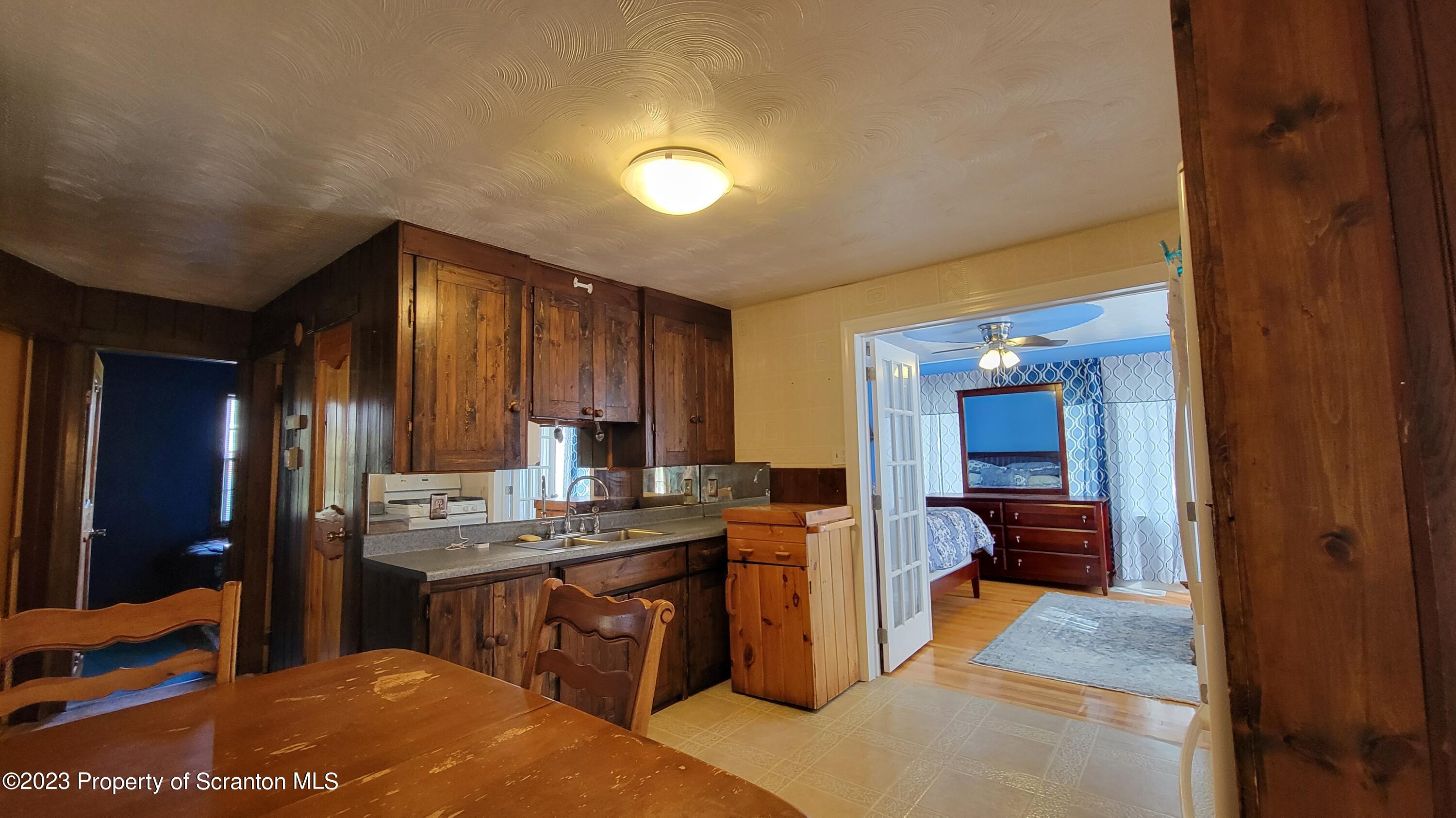 14 Main Street Hallstead, PA 18822 - Photo 7 of 16 a open kitchen with kitchen island a sink stove and refrigerator