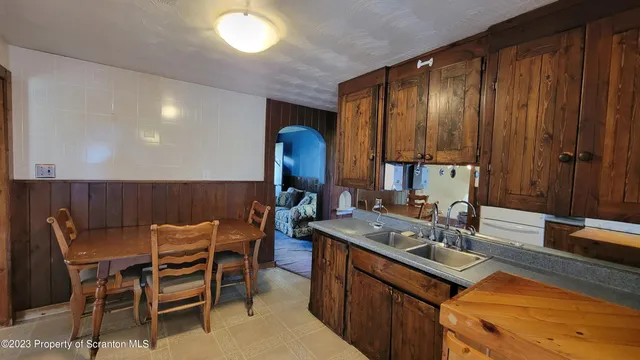a kitchen with a sink cabinets and wooden floor