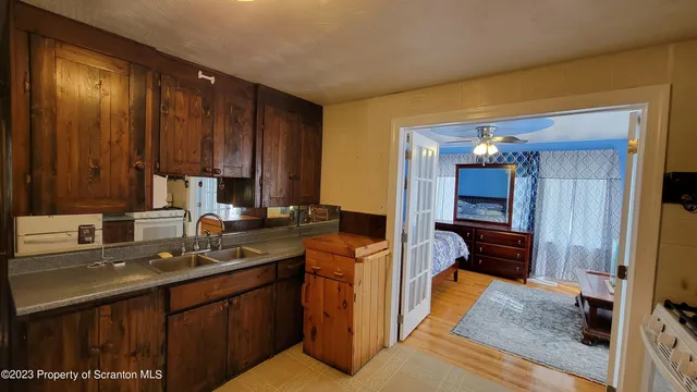 a kitchen with a sink stove and cabinets