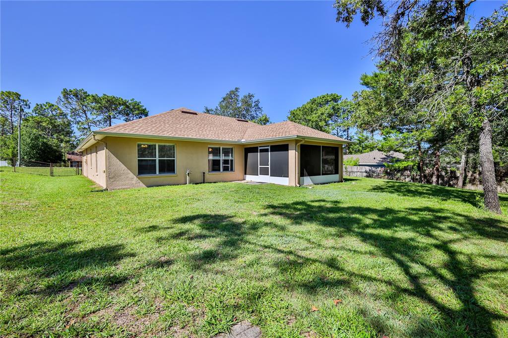 11213 Flock Avenue Weeki Wachee, FL 34613 - Photo 41 of 46 a front view of a house with a garden