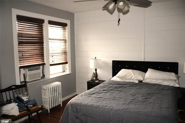 a bedroom with a bed and window