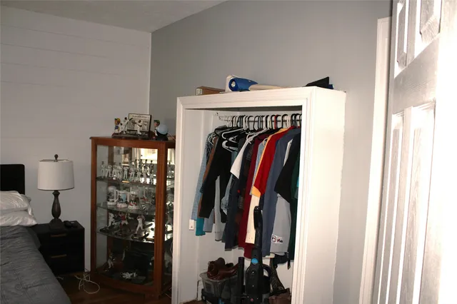 a view of walk in closet with clothes and shoes