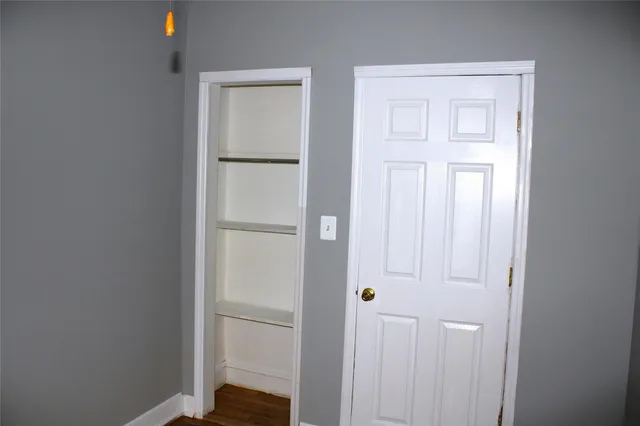 a view of a hallway with a white walls