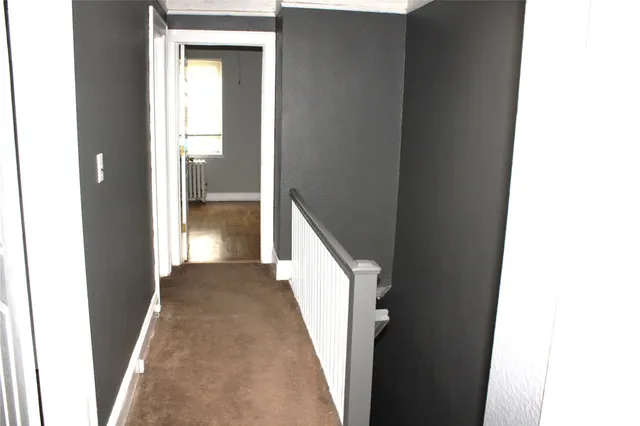 a view of a hallway with toilet