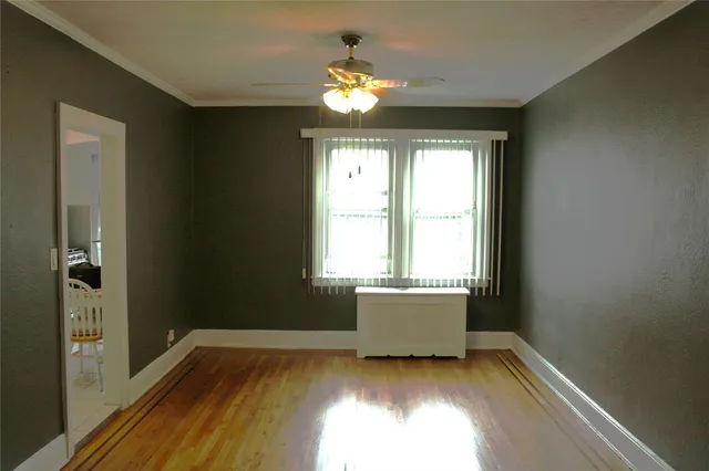 a view of wooden floor and a chandelier in big room