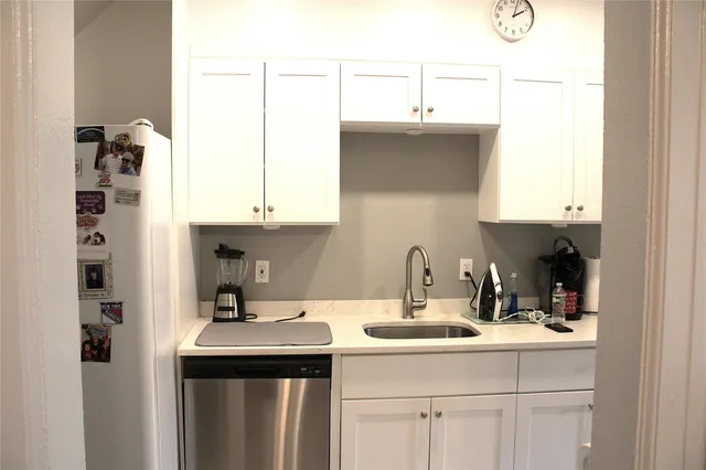 a kitchen with a sink and cabinets