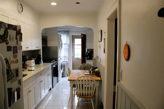 a bathroom with a tub a sink and a mirror