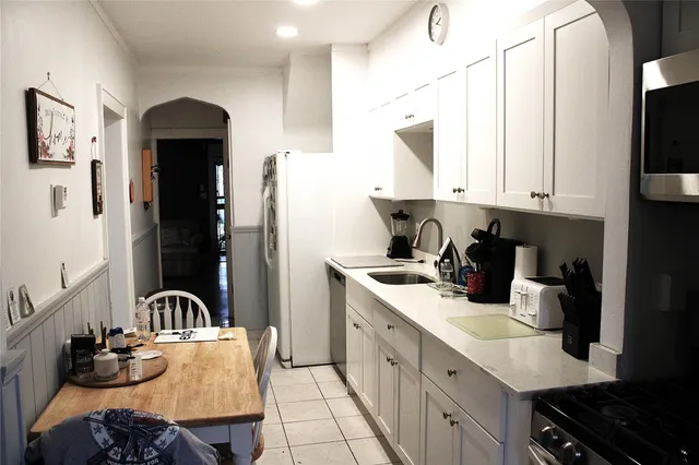 a kitchen with stainless steel appliances granite countertop a stove white cabinets a sink and dishwasher
