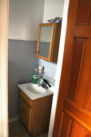 a bathroom with a sink a mirror and vanity
