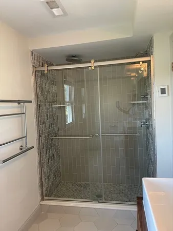 a bathroom with a shower and a sink
