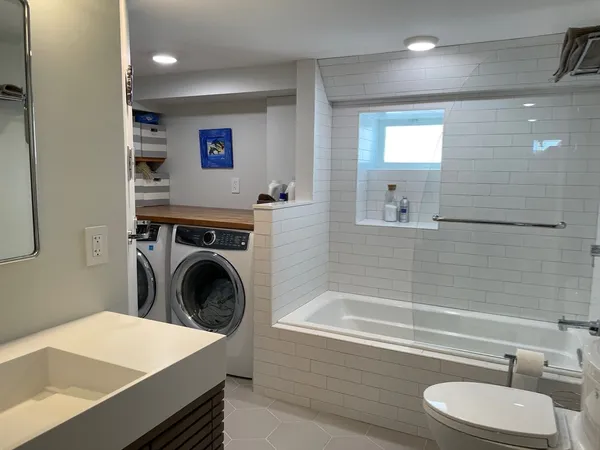 a bathroom with a sink a mirror and a bathtub