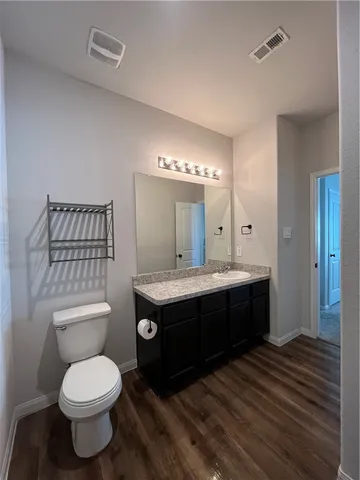 a bathroom with a granite countertop sink a large mirror and a shower
