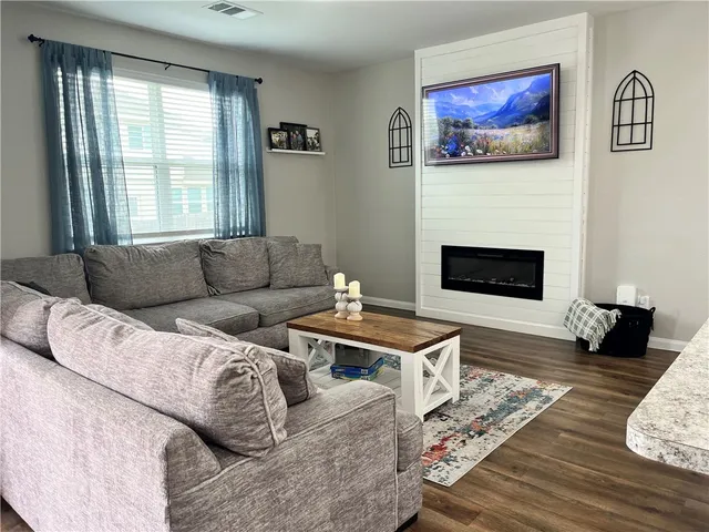 a living room with furniture and a large window
