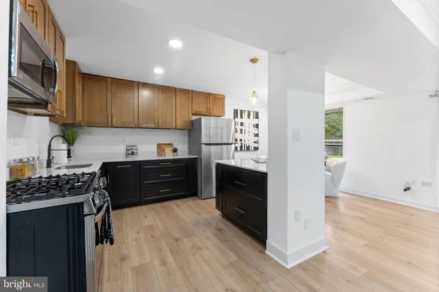 a kitchen with granite countertop cabinets and steel stainless steel appliances