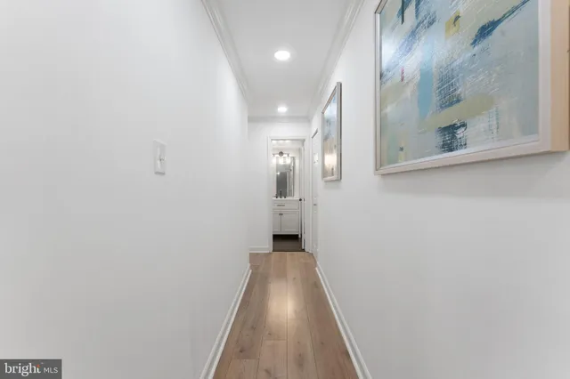 a view of a hallway with wooden floor