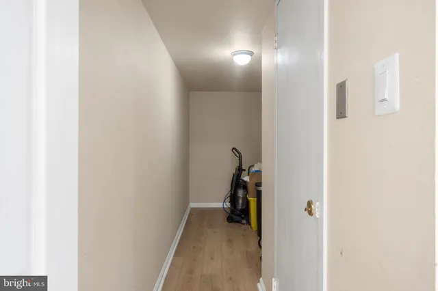 a view of a brick house with a yard and large tree