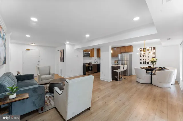 a living room with furniture and a wooden floor