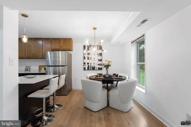 a dining room with furniture and wooden floor