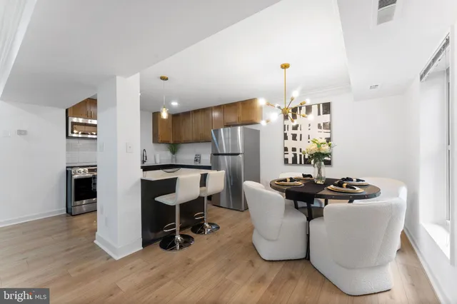 a dining room with furniture and wooden floor