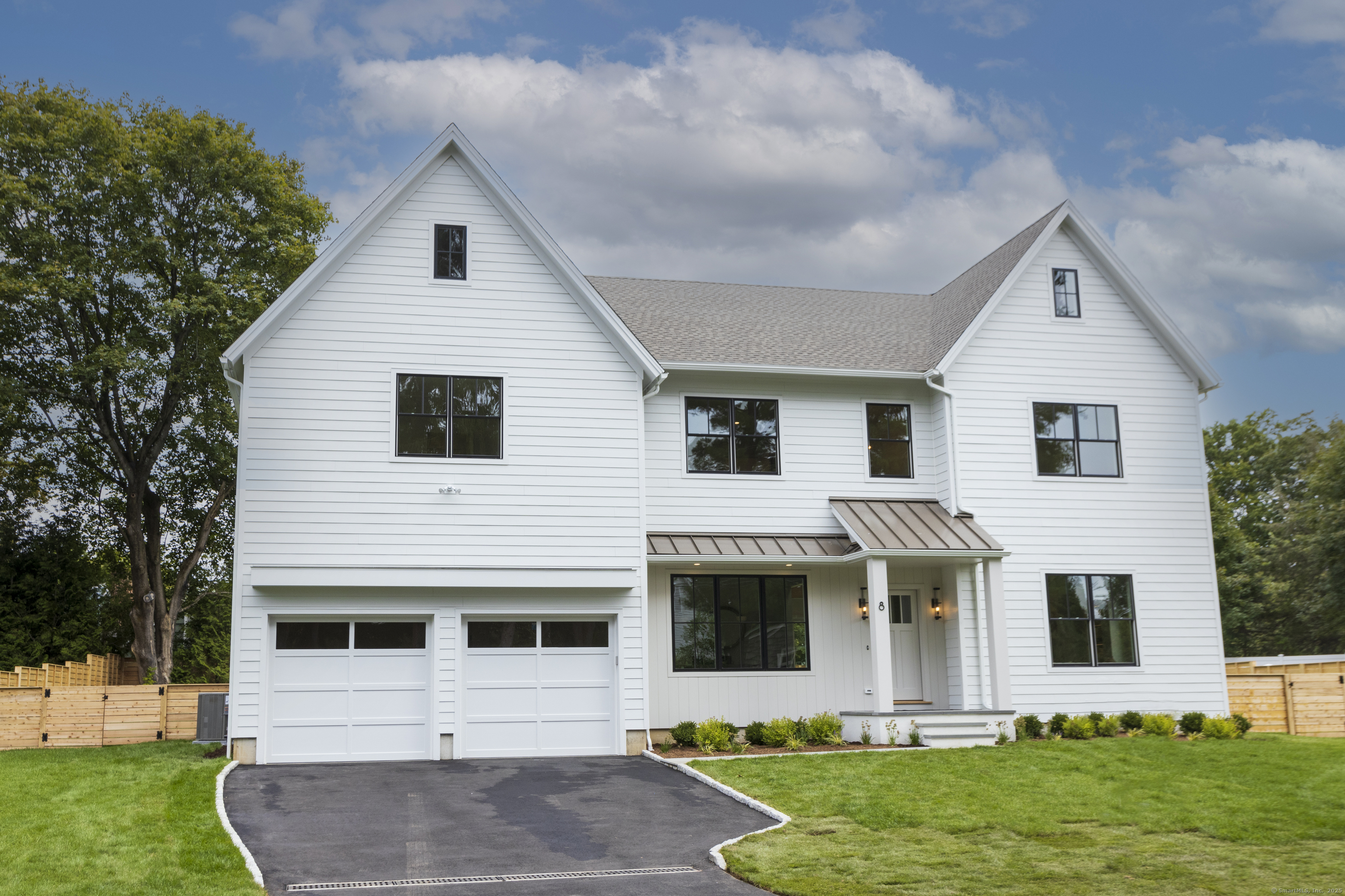 8 Fillow Street Westport, CT 06880 - Photo 1 of 1 a front view of a house with a yard and garage