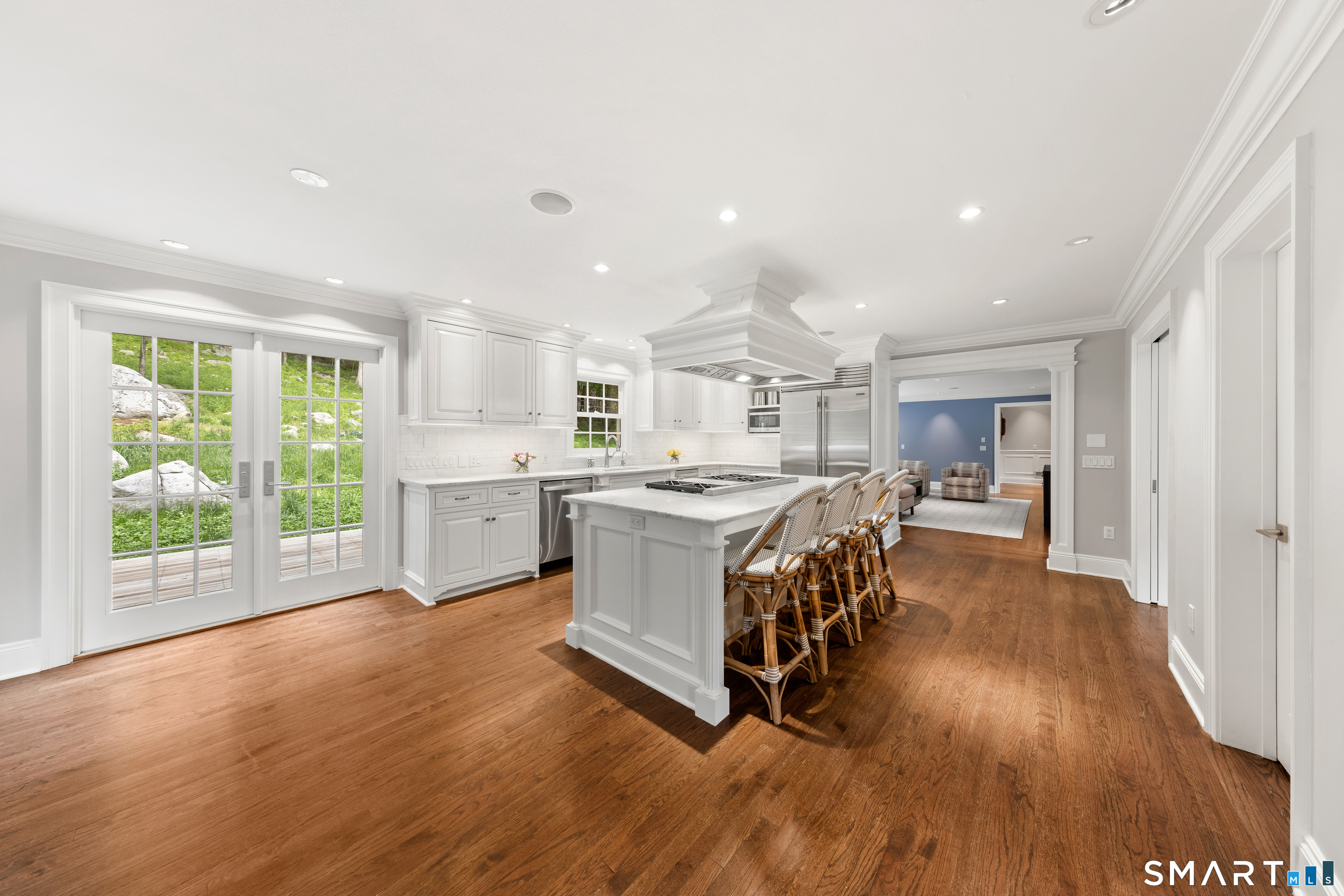 99 Hickok Road New Canaan, CT 06840 - Photo 9 of 39 a kitchen with stainless steel appliances granite countertop a stove oven a refrigerator with white cabinets and wooden floor