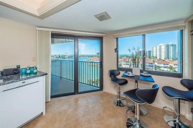 a living room with furniture and floor to ceiling window