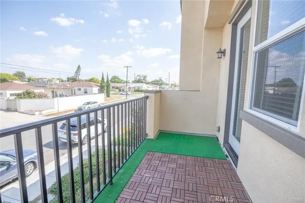 a view of a balcony with a yard