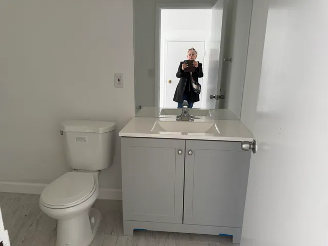 a white toilet sitting next to a sink