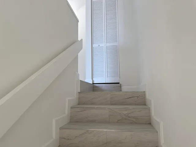 a white toilet sitting next to a bathroom sink