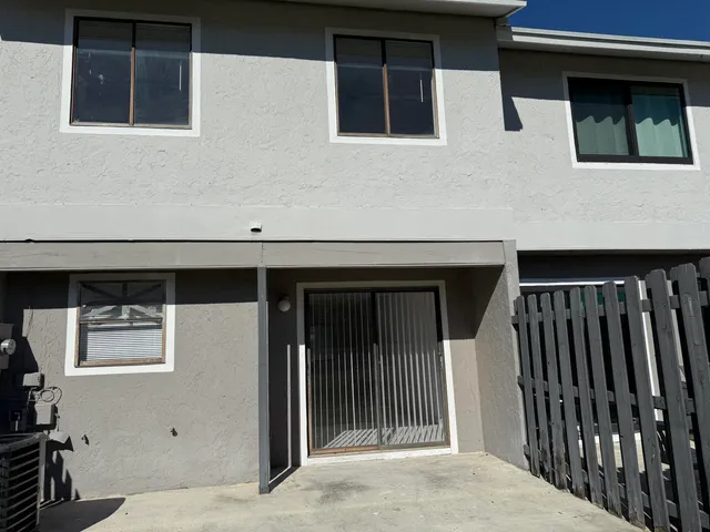 a backyard of a house with lots of green space and trampoline
