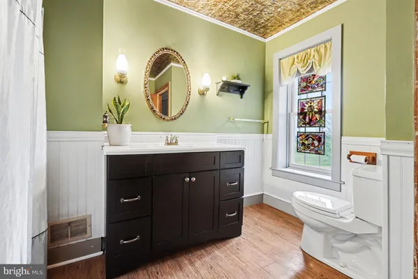 a bathroom with a sink a mirror and a vanity