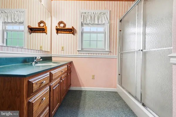 a kitchen with granite countertop a sink and a refrigerator