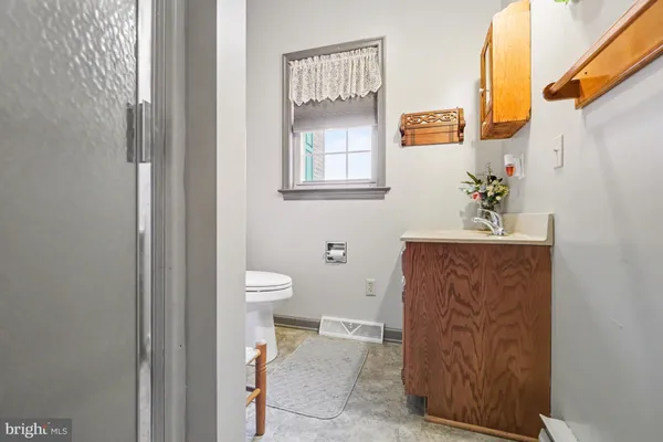 a bathroom with a toilet sink and mirror
