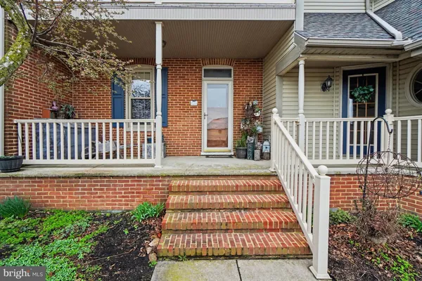 a view of a house with a small deck