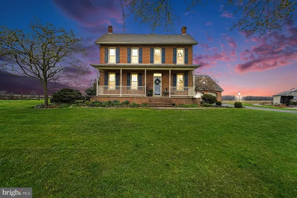 a view of a brick house with a yard