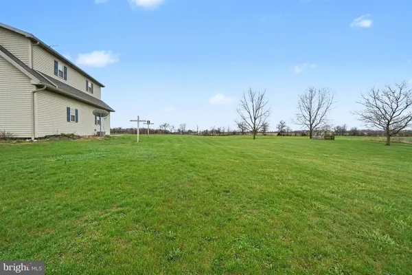 a backyard of a house with lots of green space and trees