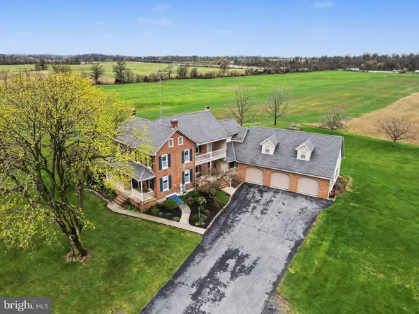 an aerial view of a house with a garden and outdoor seating