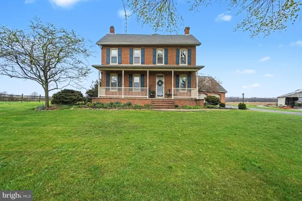 a view of a brick house with a yard