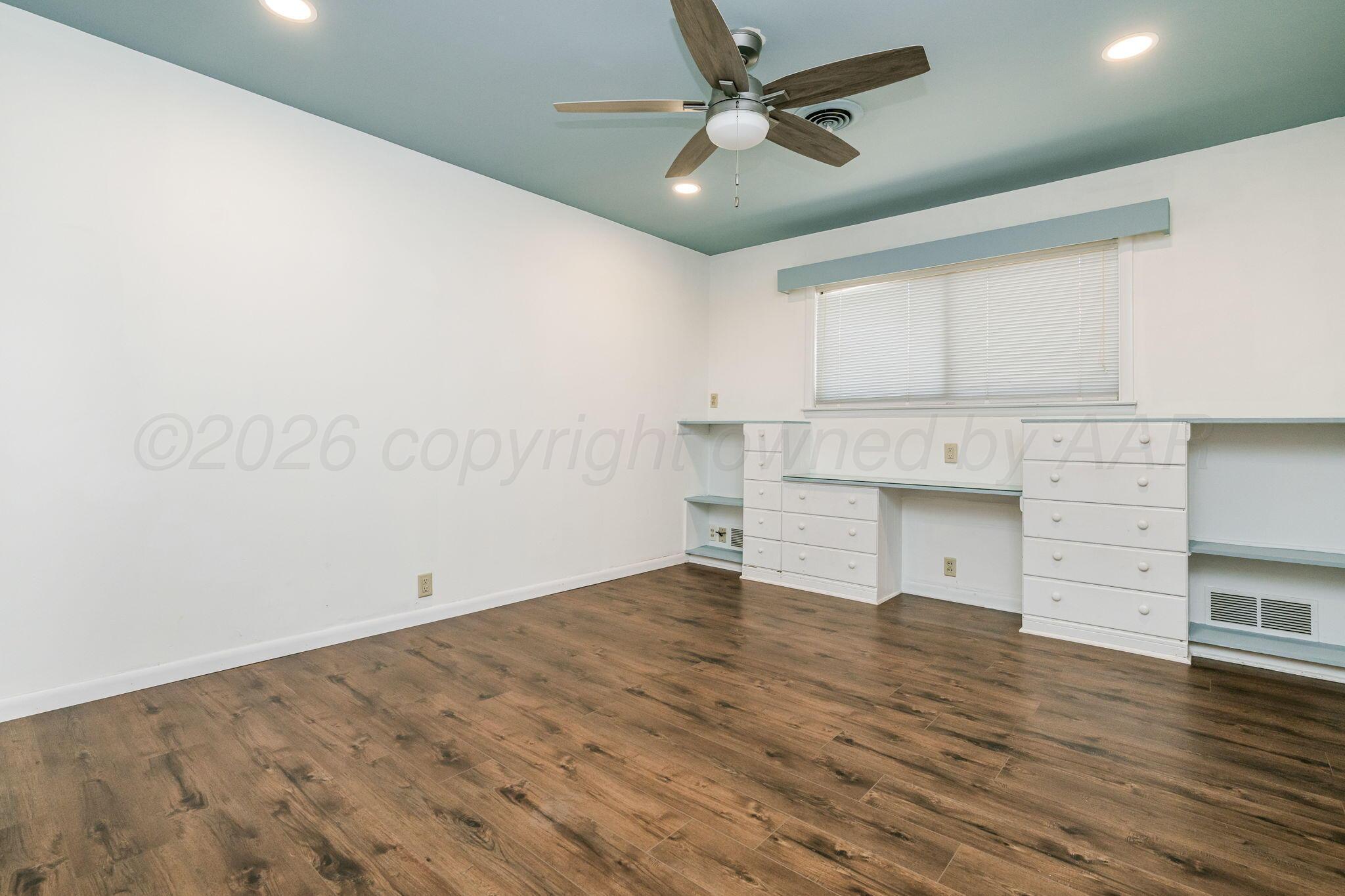 1018 South Bryan Street Amarillo, TX 79102 - Photo 13 of 41 a view of empty room with wooden floor and fan