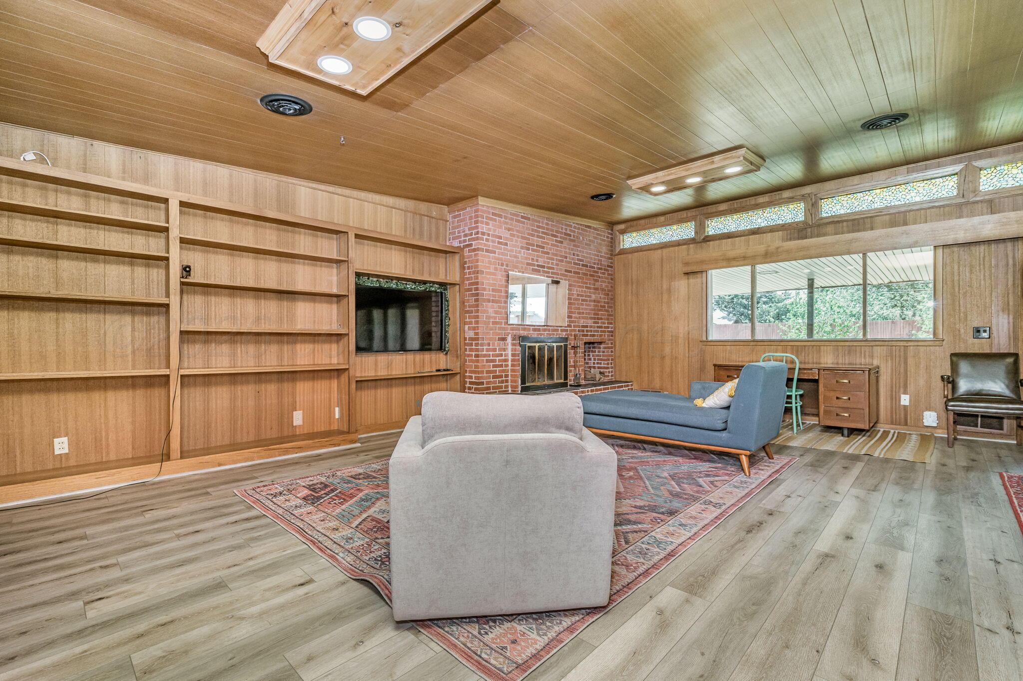 1018 South Bryan Street Amarillo, TX 79102 - Photo 2 of 41 a living room with furniture and a wooden floor